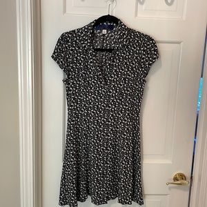 Black and white mid-thigh length dress. Adjustable tie in the back